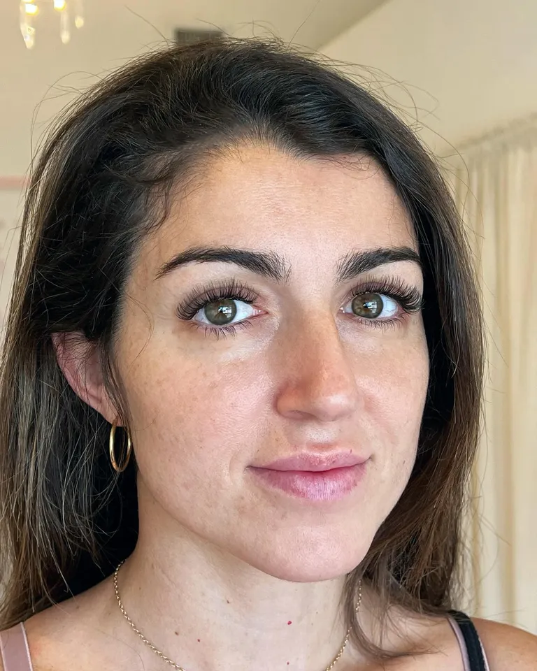 Portrait of a client wearing a soft hybrid eyelash extension set with natural length and light volume by Made by Marissa.