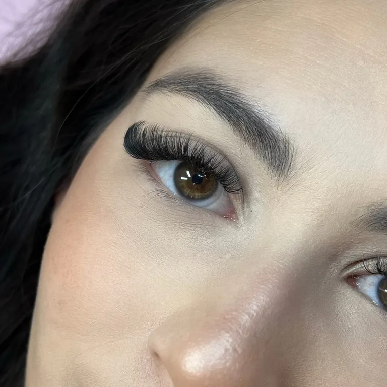 Close-up of a full volume eyelash extension set with dense black fans and a dramatic cat-eye shape by Made by Marissa.